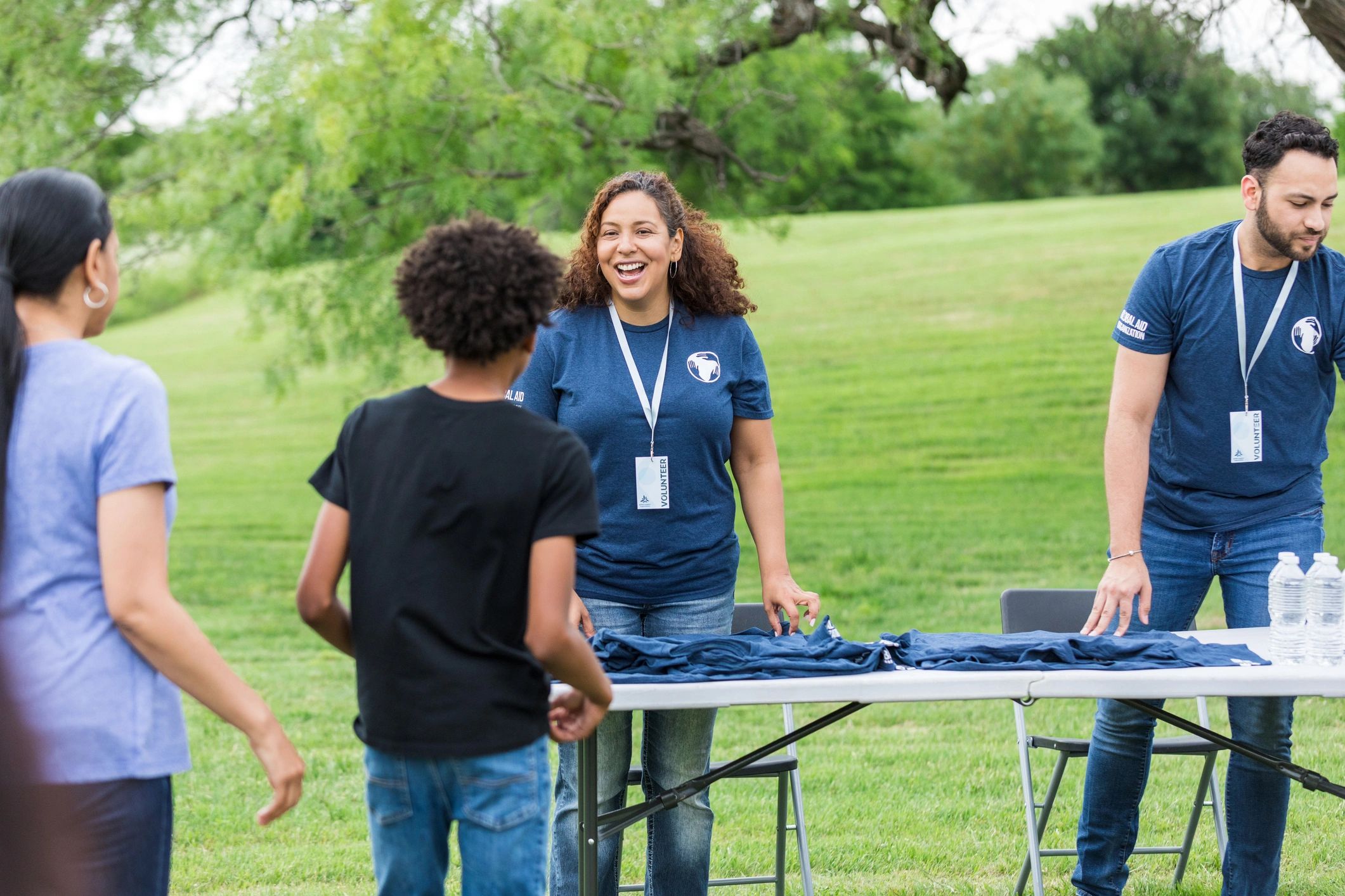 Volunteer welcoming a child at a community program