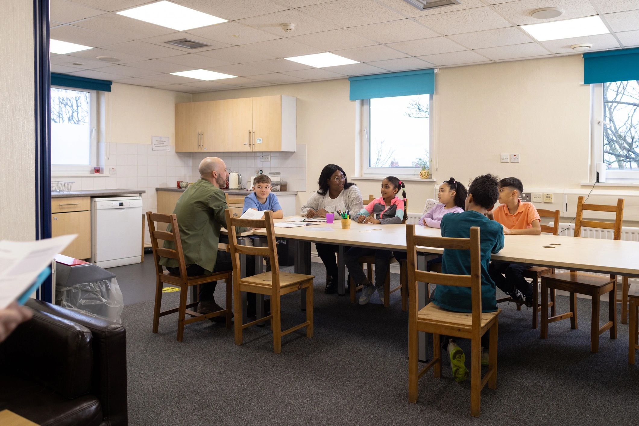 Children and mentors in a supportive group discussion